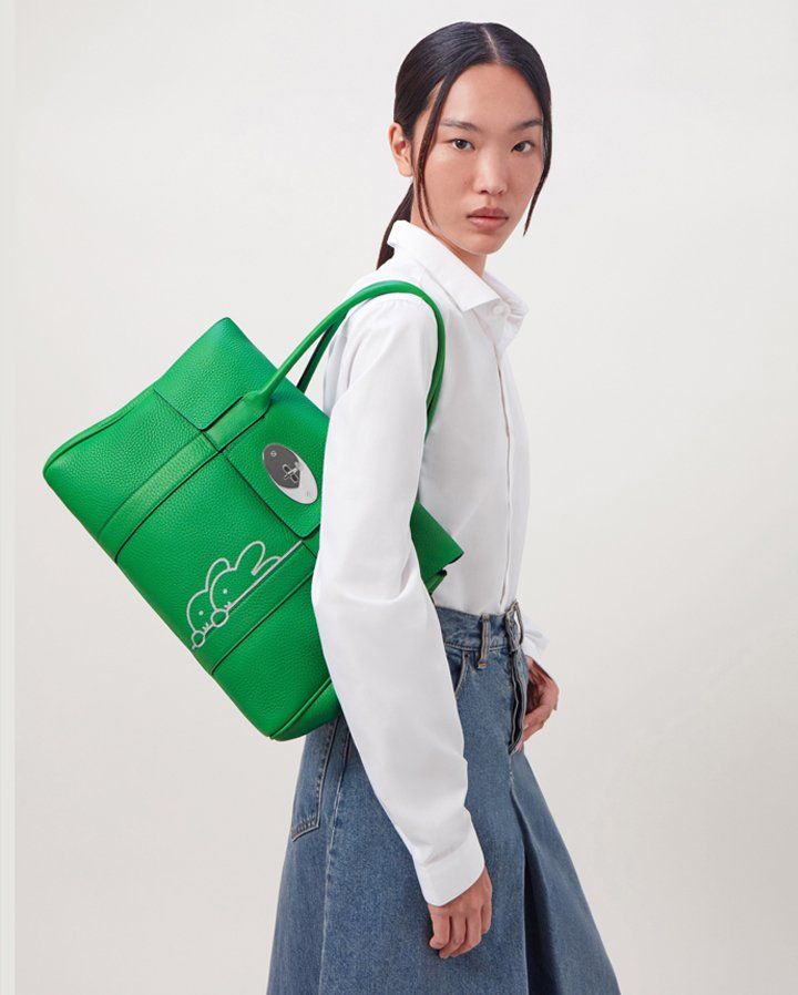 model wearing mulberry bayswater bag in green with miffy character print