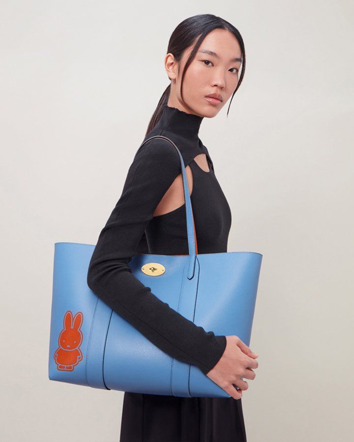 model wearing mulberry bayswater tote bag in blue with orange miffy character print