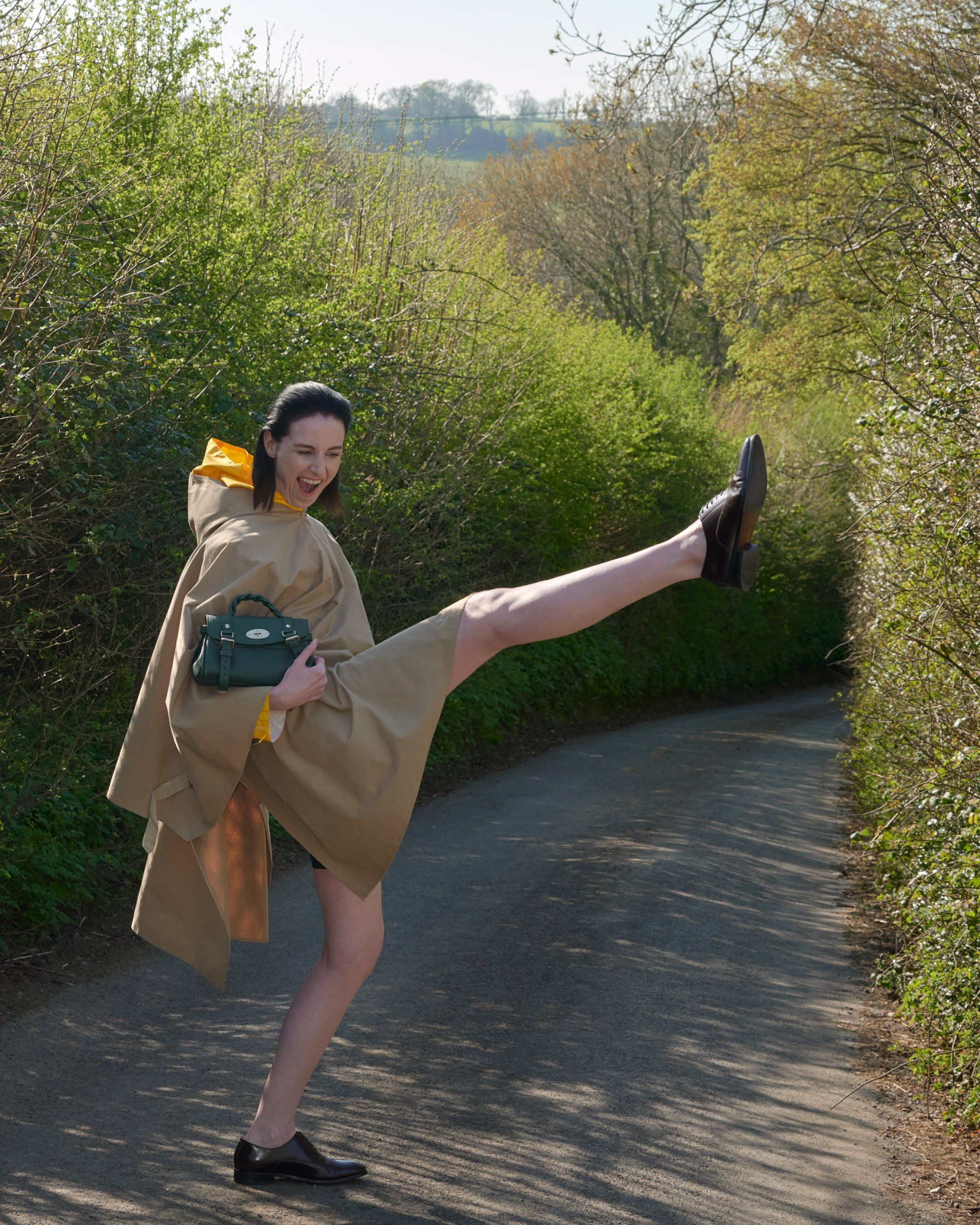 Model holding the Mulberry Mini Alexa bag in dark green leather