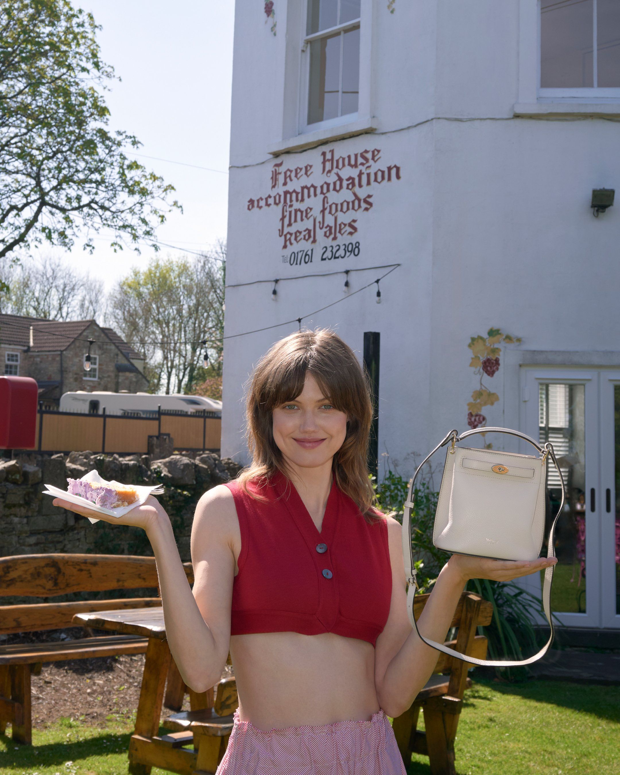 Model holding the Mulberry Mini Islington bag in cream leather
