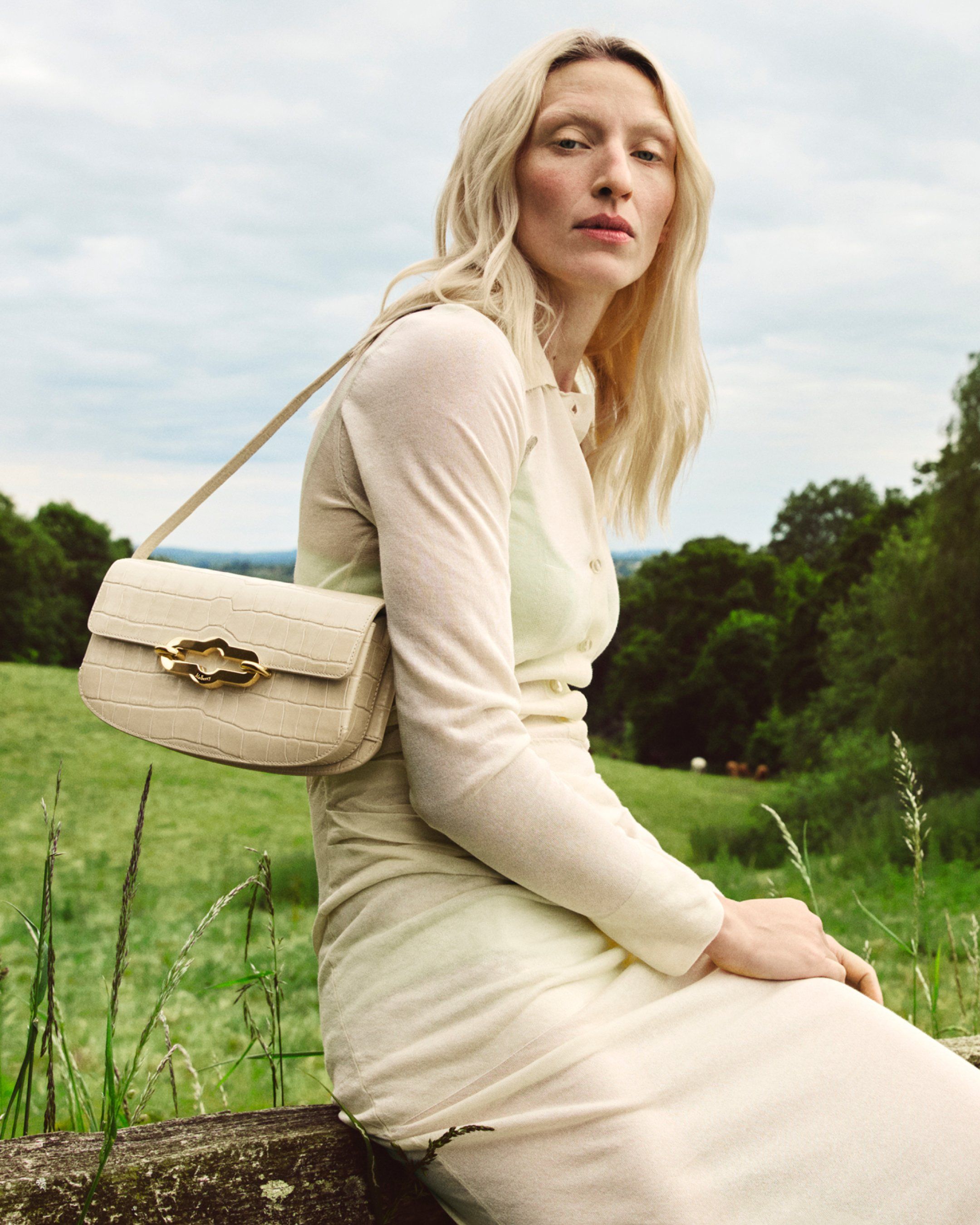 Model wearing Mulberry East West Pimlico bag in eggshell croc print