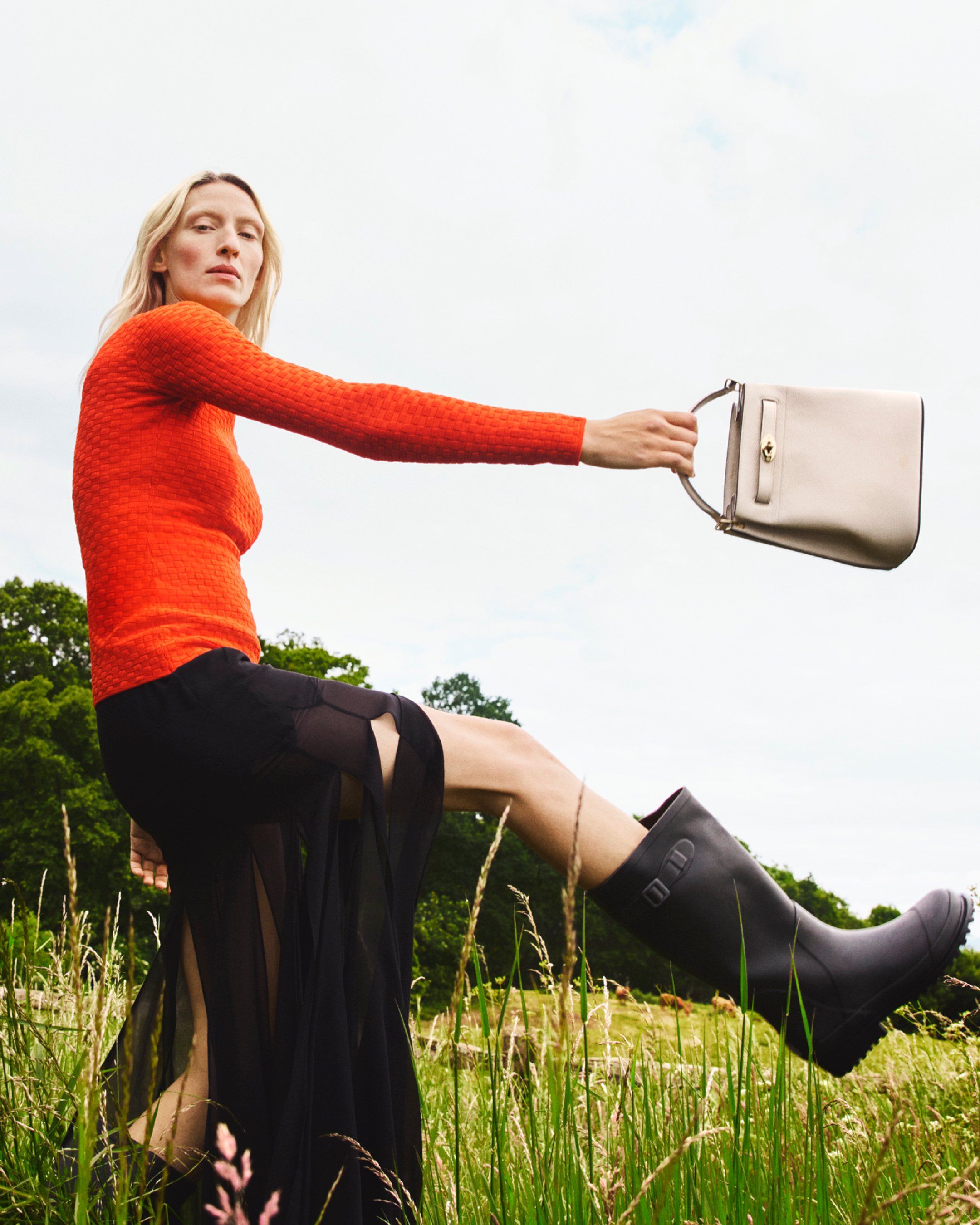 Model holding the Islington Bucket Bag from Mulberry in chalk leather