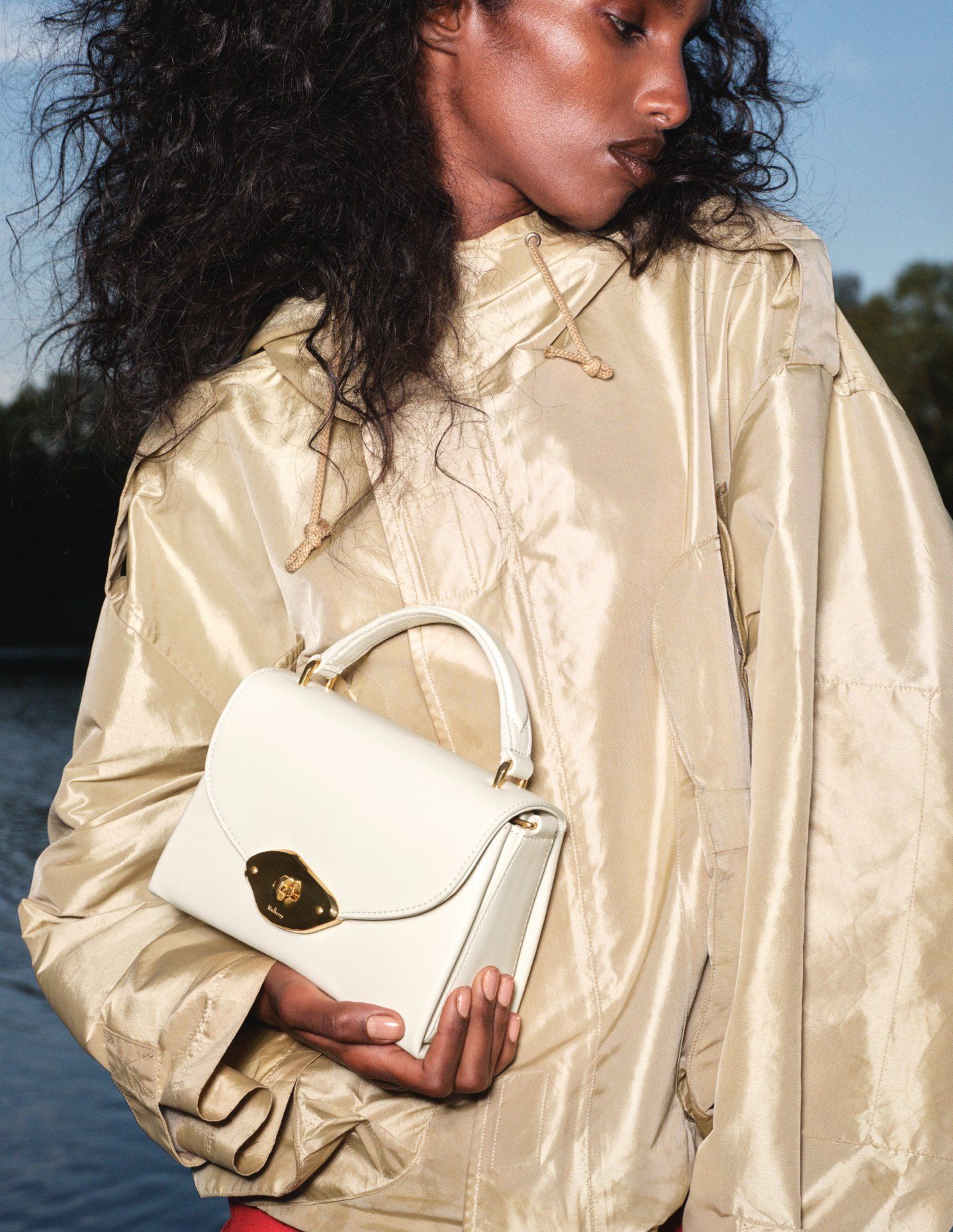 model wearing small lana top handle bag in eggshell