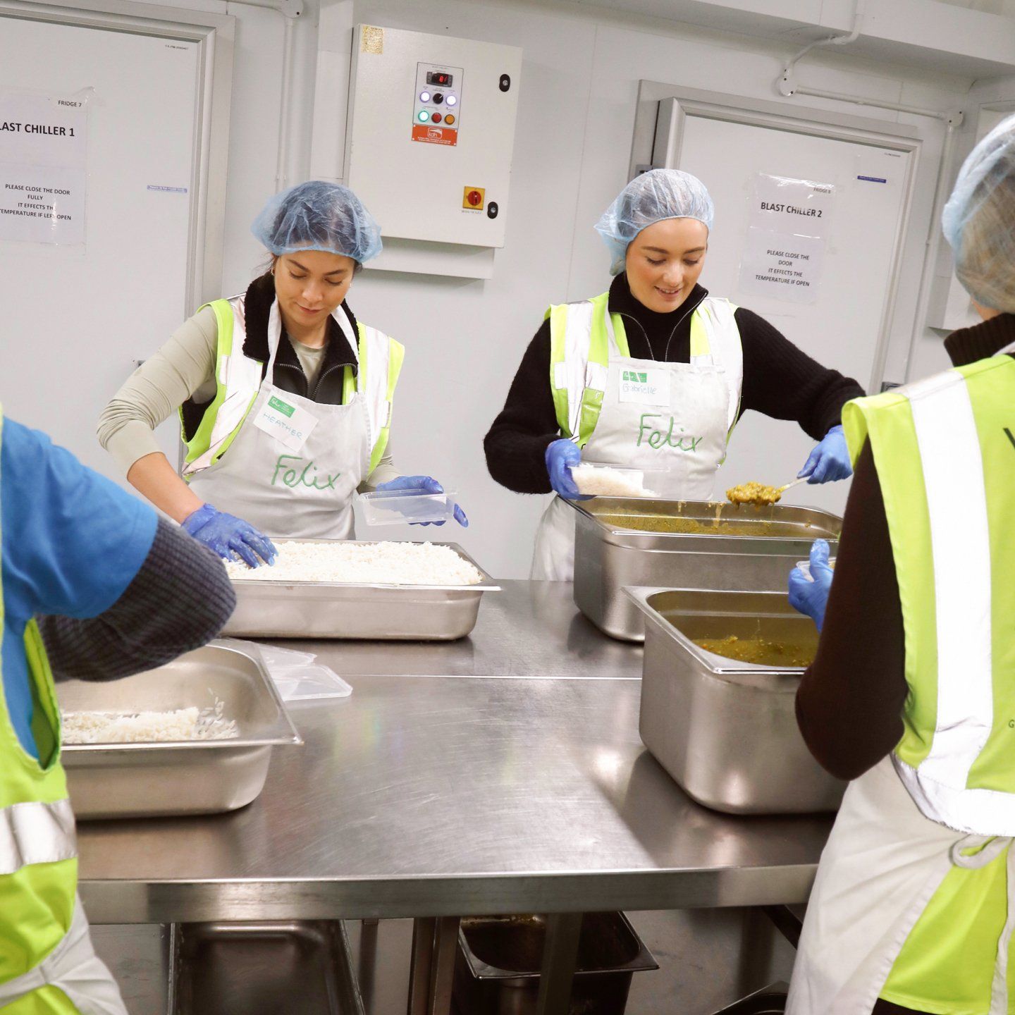 Volunteers working packaging food at the Felix Project charity