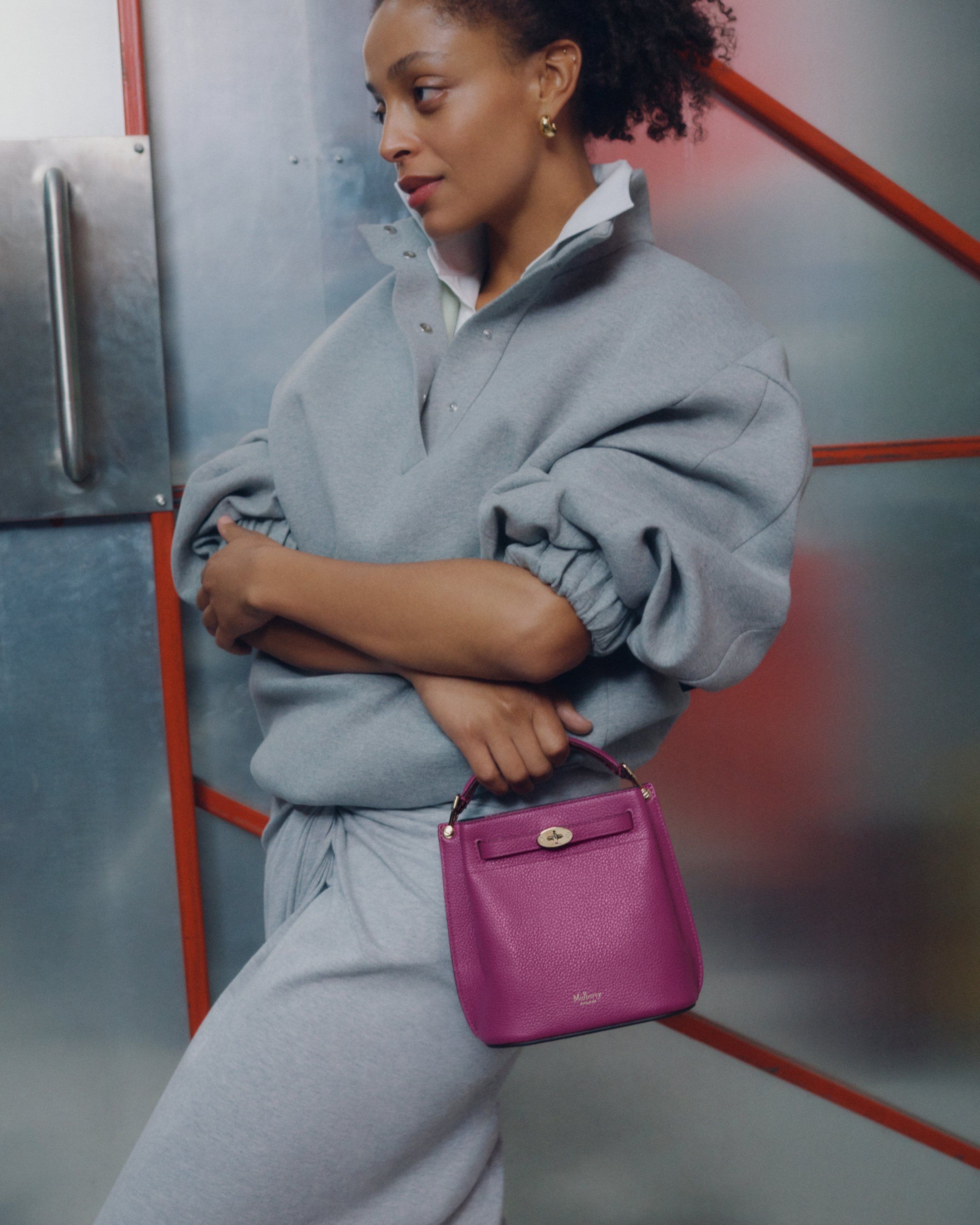 Model holding the Mulberry Mini Islington bag in purple leather