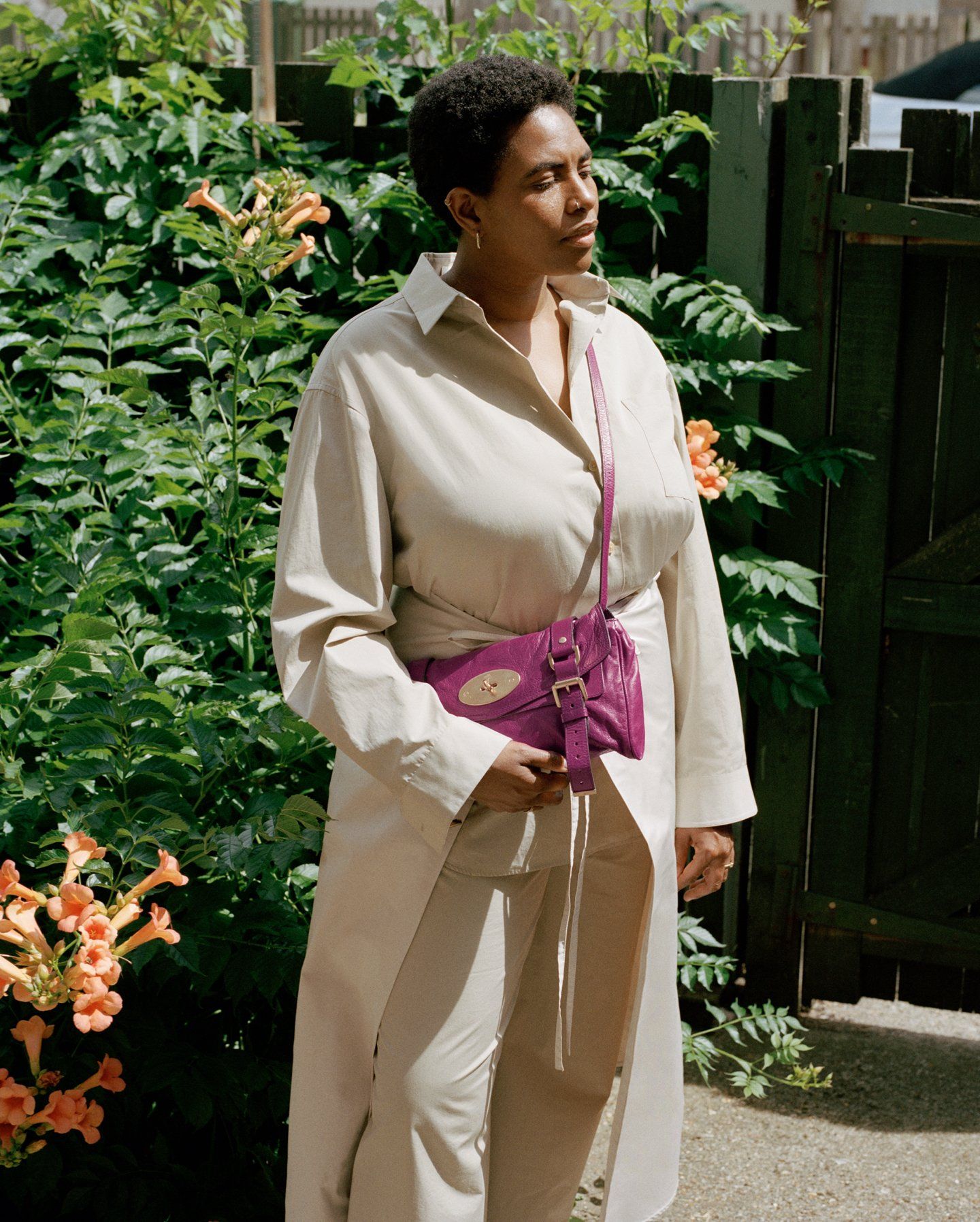 Woman in a beige outfit standing outside wearing a pink Mulberry Alexa bag