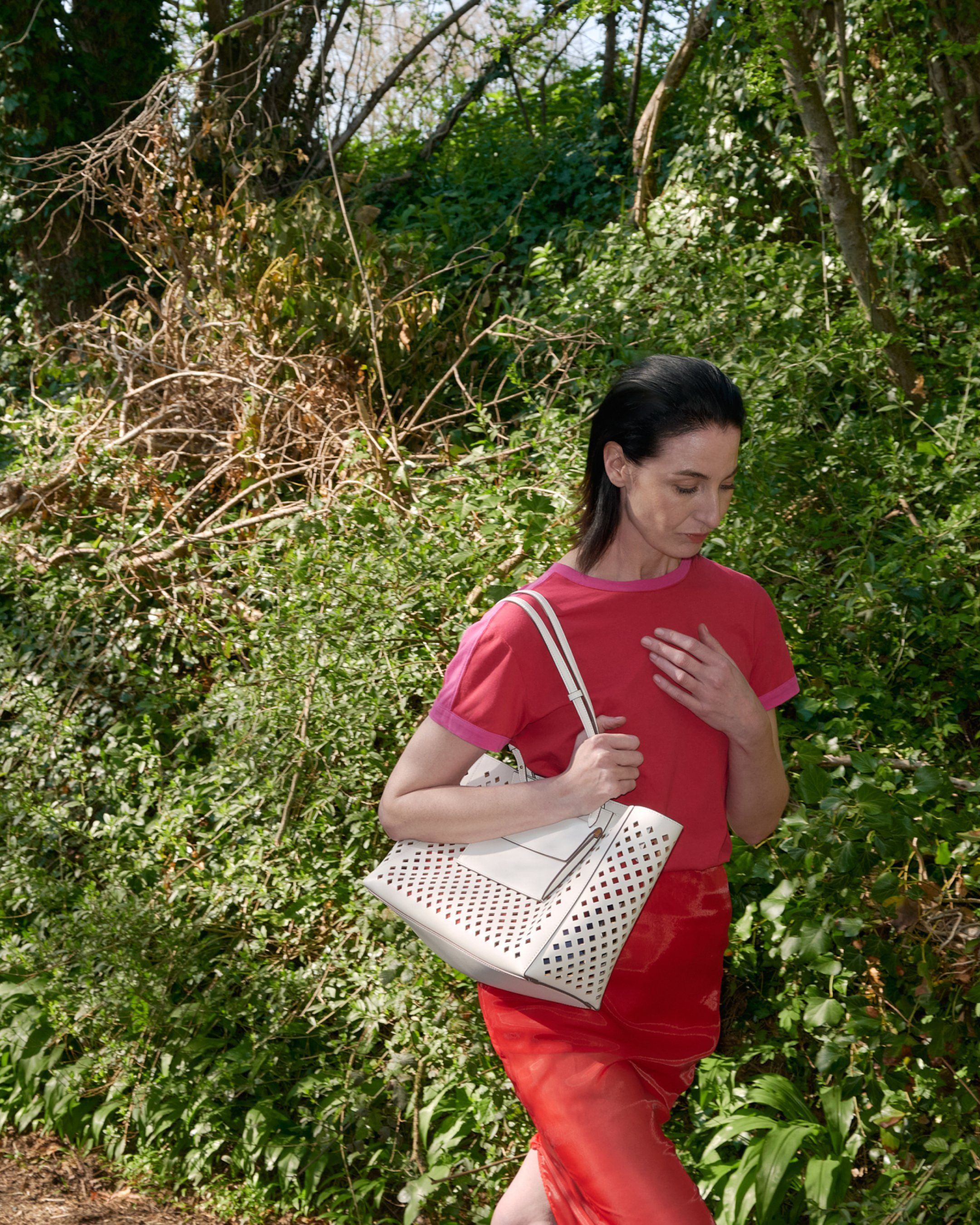 Female model wearing Mulberry perforated leather tote bag in white leather