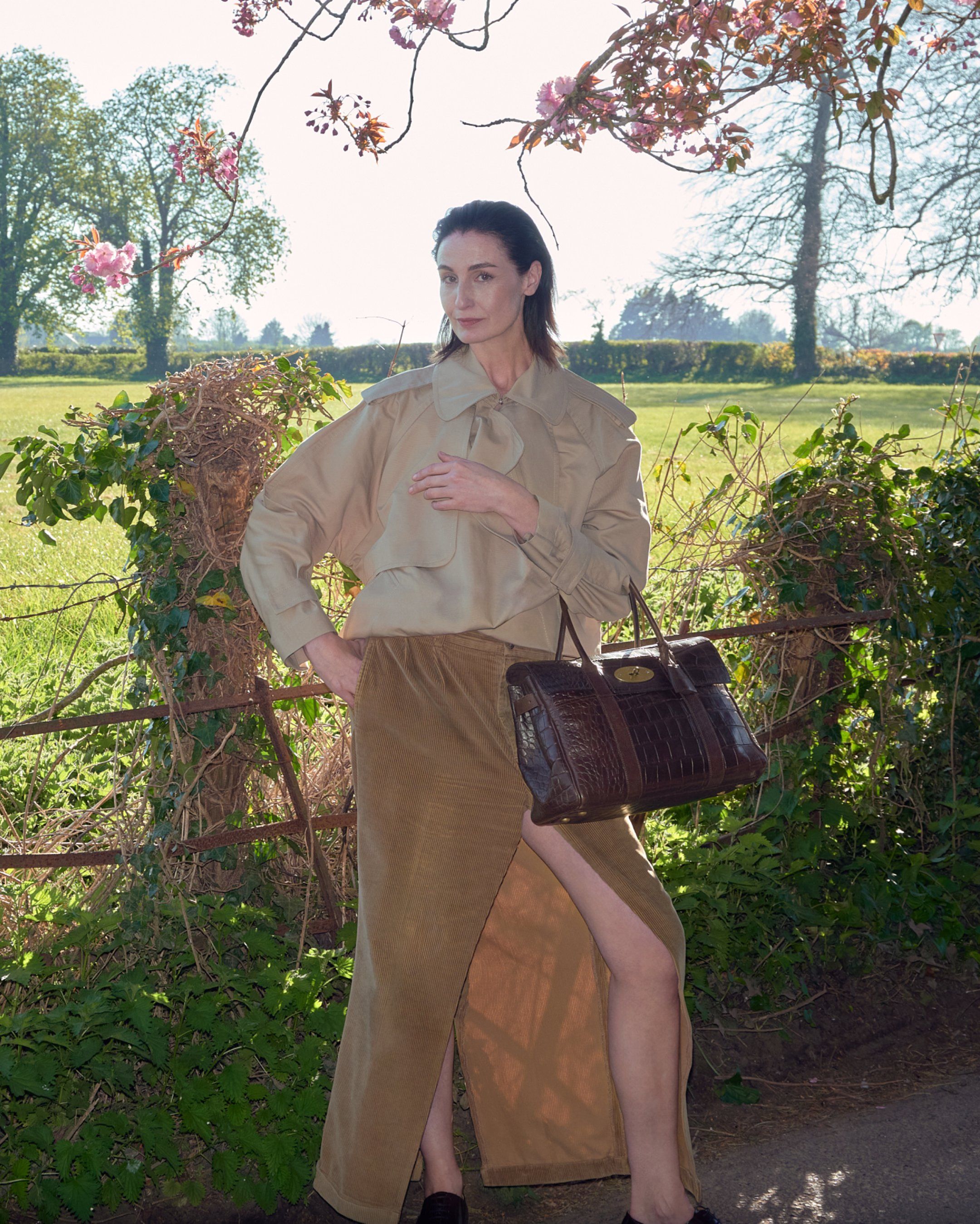 Female model wearing Mulberry pre loved Bayswater bag in chocolate brown leather