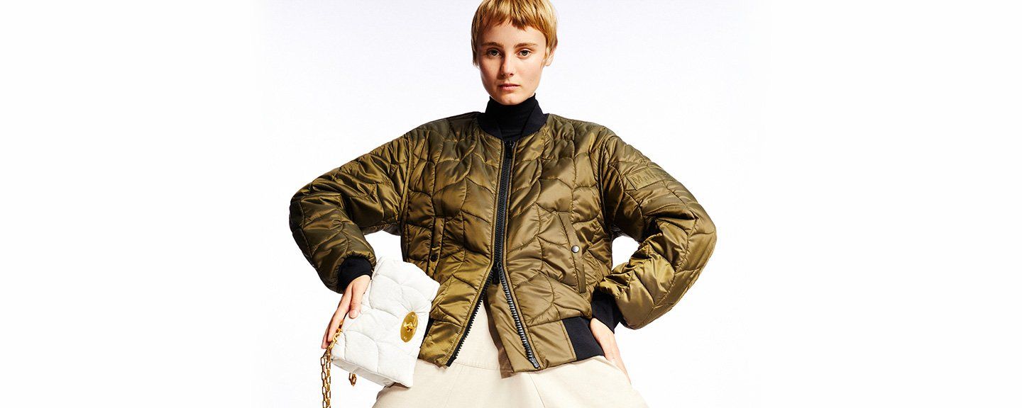 Model wearing the Softie jacket and Softie handbag in white