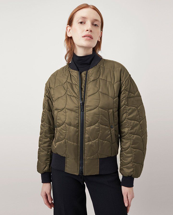 Model wearing the Softie Quilted Bomber in Khaki Recycled Nylon