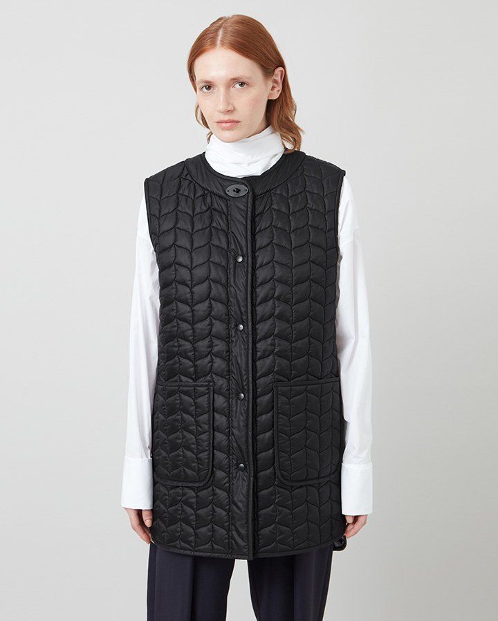 Model wearing the Softie Quilted Sleeveless Coat in Black Recycled Nylon