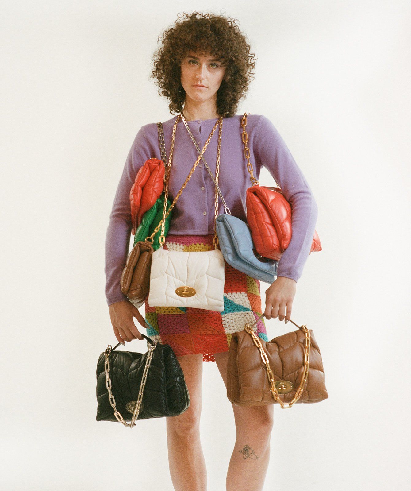 Woman holding multiple Softie handbags