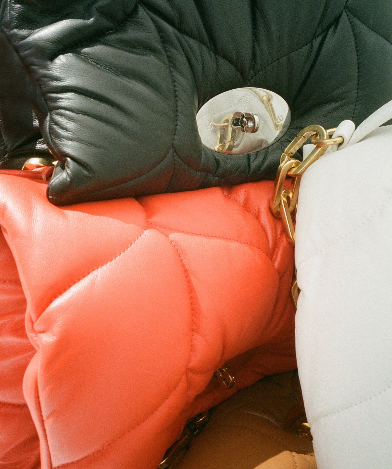 Closeup of Softie handbags in black, orange and white