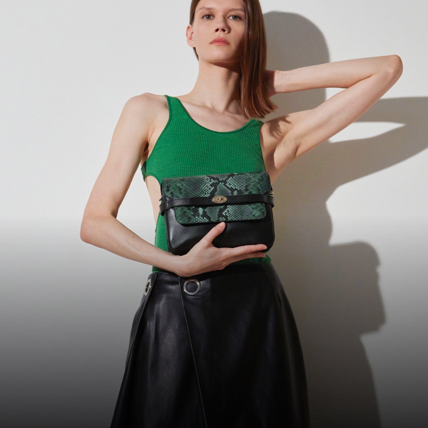 model wearing mulberry belted bag in faux snakeskin print