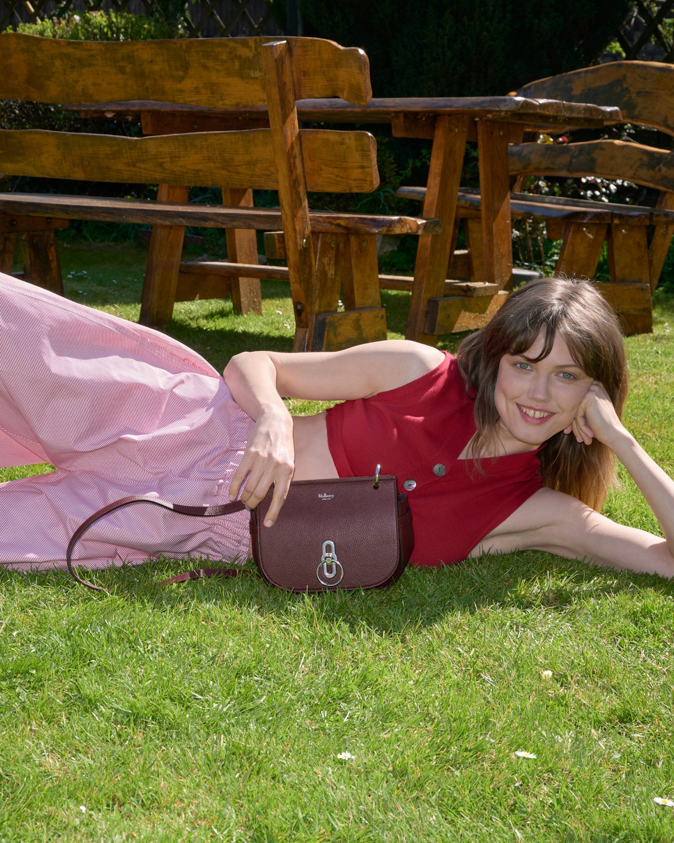 female model wearing Mulberry small Amberley satchel bag in burgundy leather