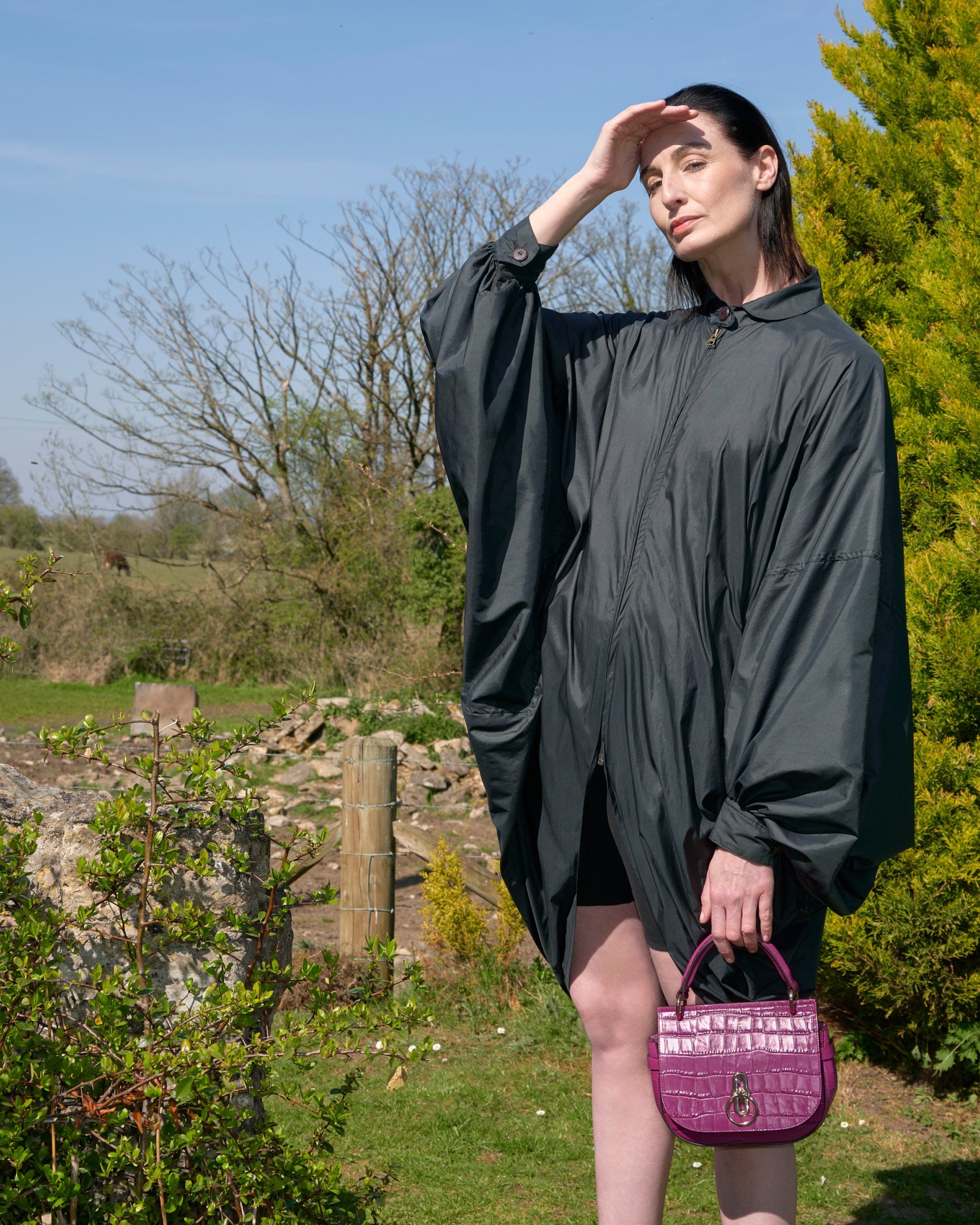 Model holding the Mulberry Small Amberley Satchel in purple leather with croc print