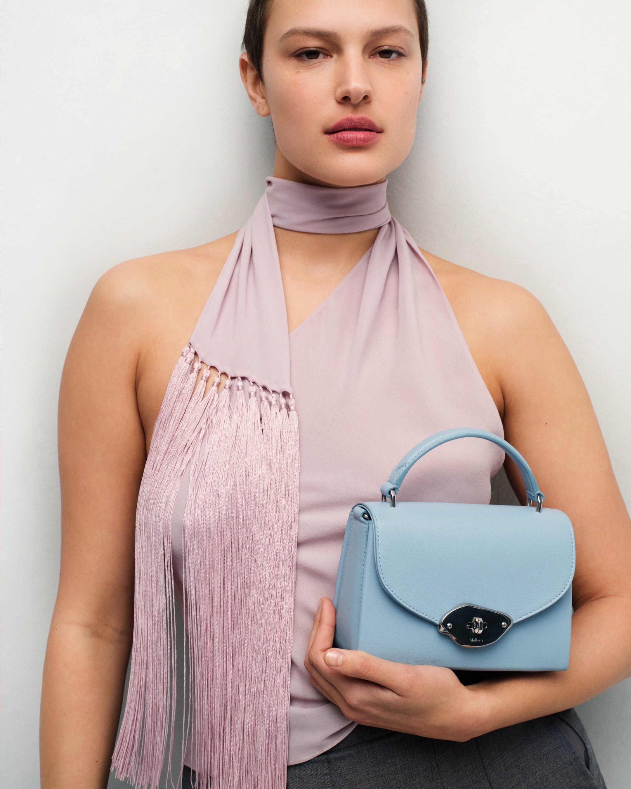 Model holding the Small Lana bag in blue leather