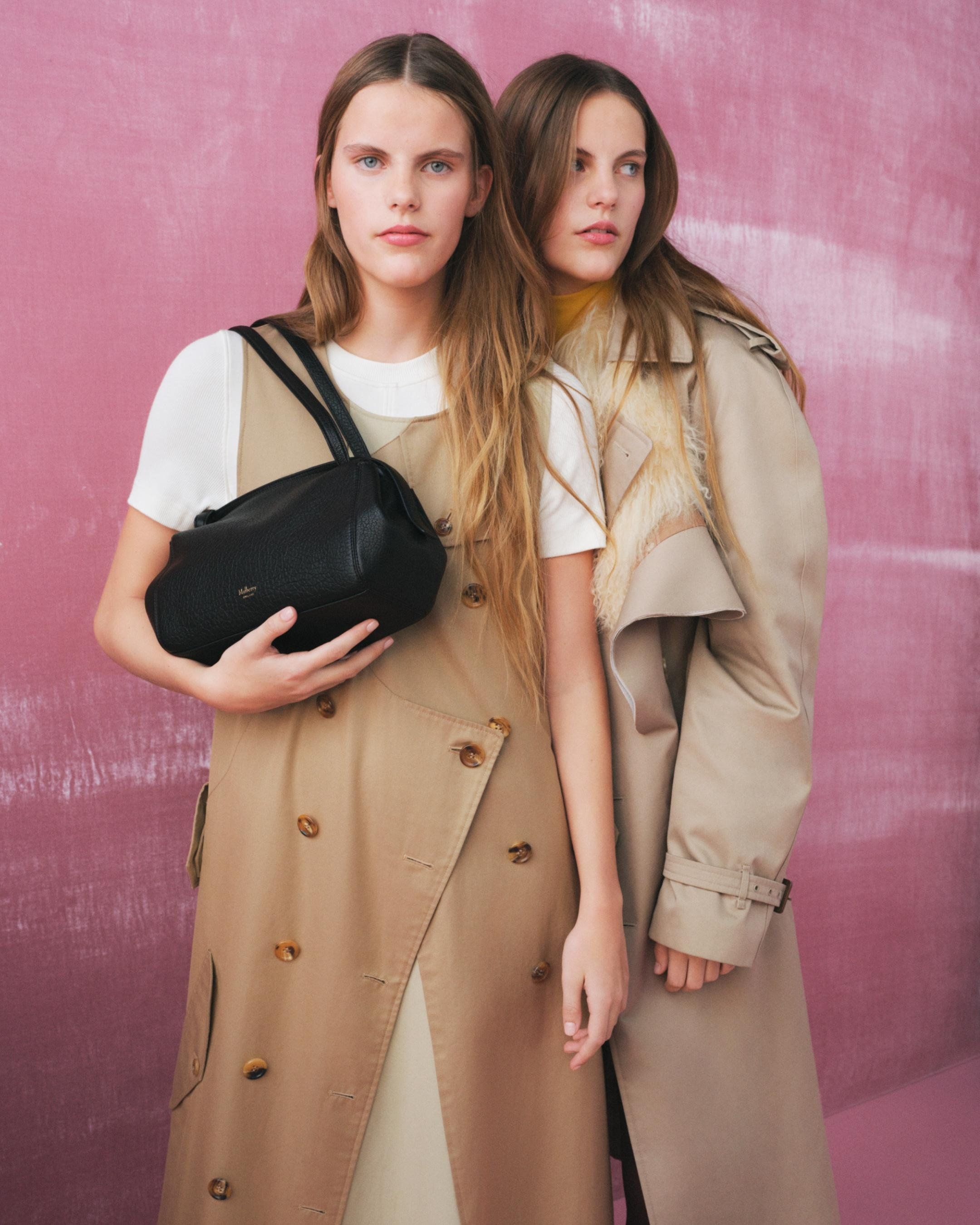 Two models holding the Mulberry Small Meadow bag in black leather