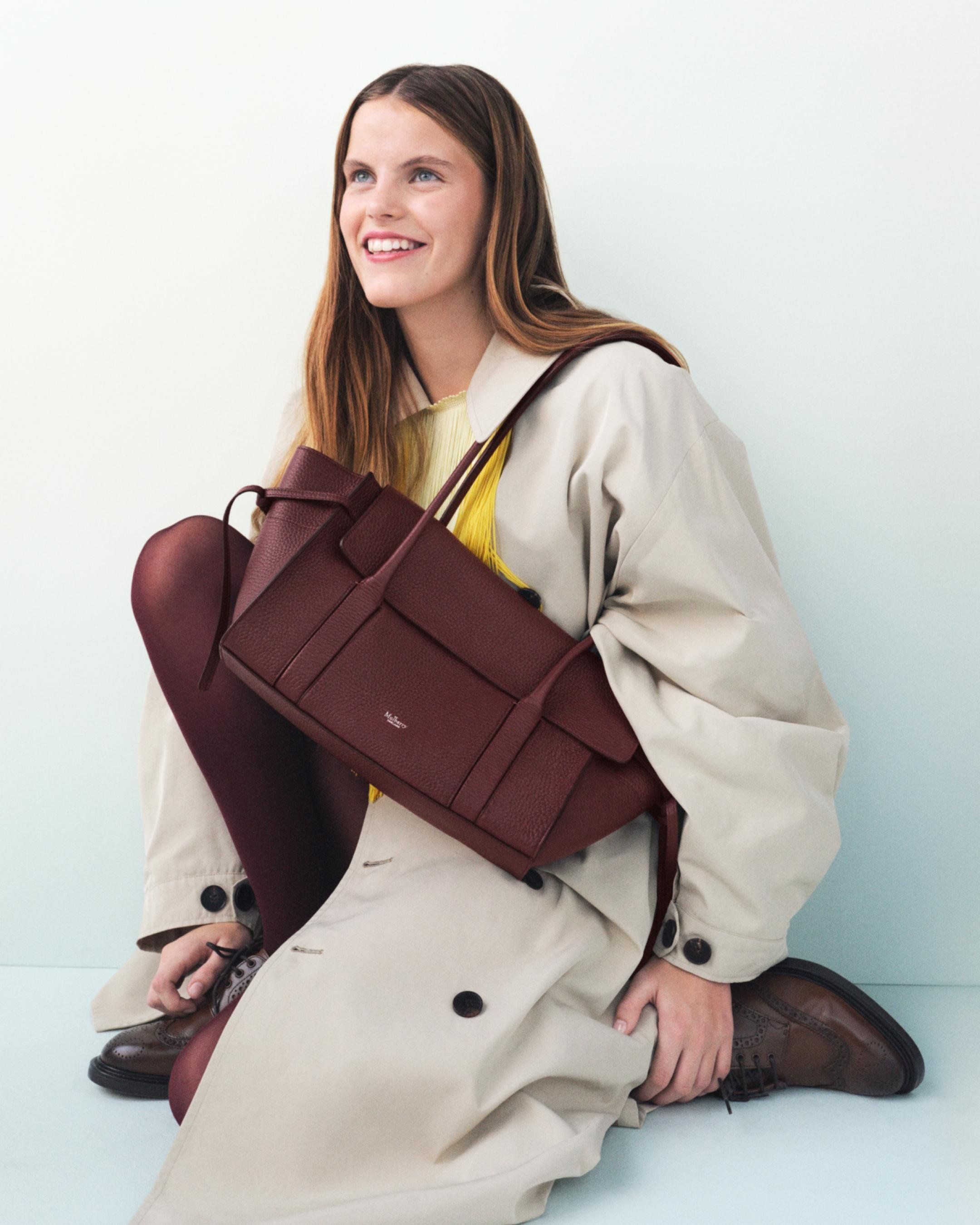 Model holding the Mulberry Small Soft Bayswater in burgundy leather