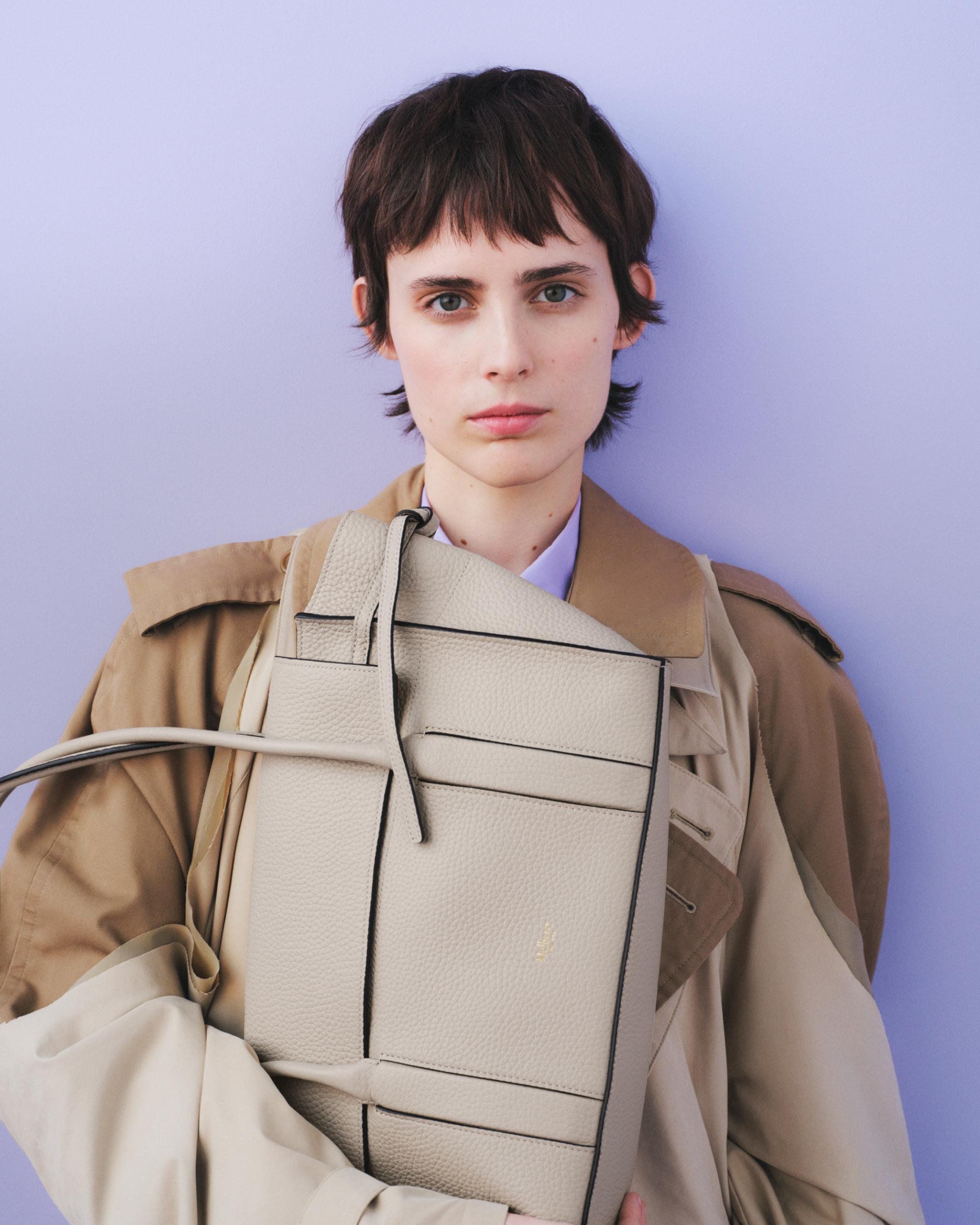 Model holding the Mulberry Small Soft Bayswater bag in cream leather