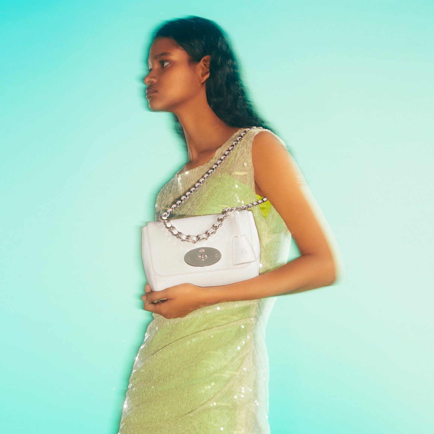 Model holding a white Lily bag from Mulberry