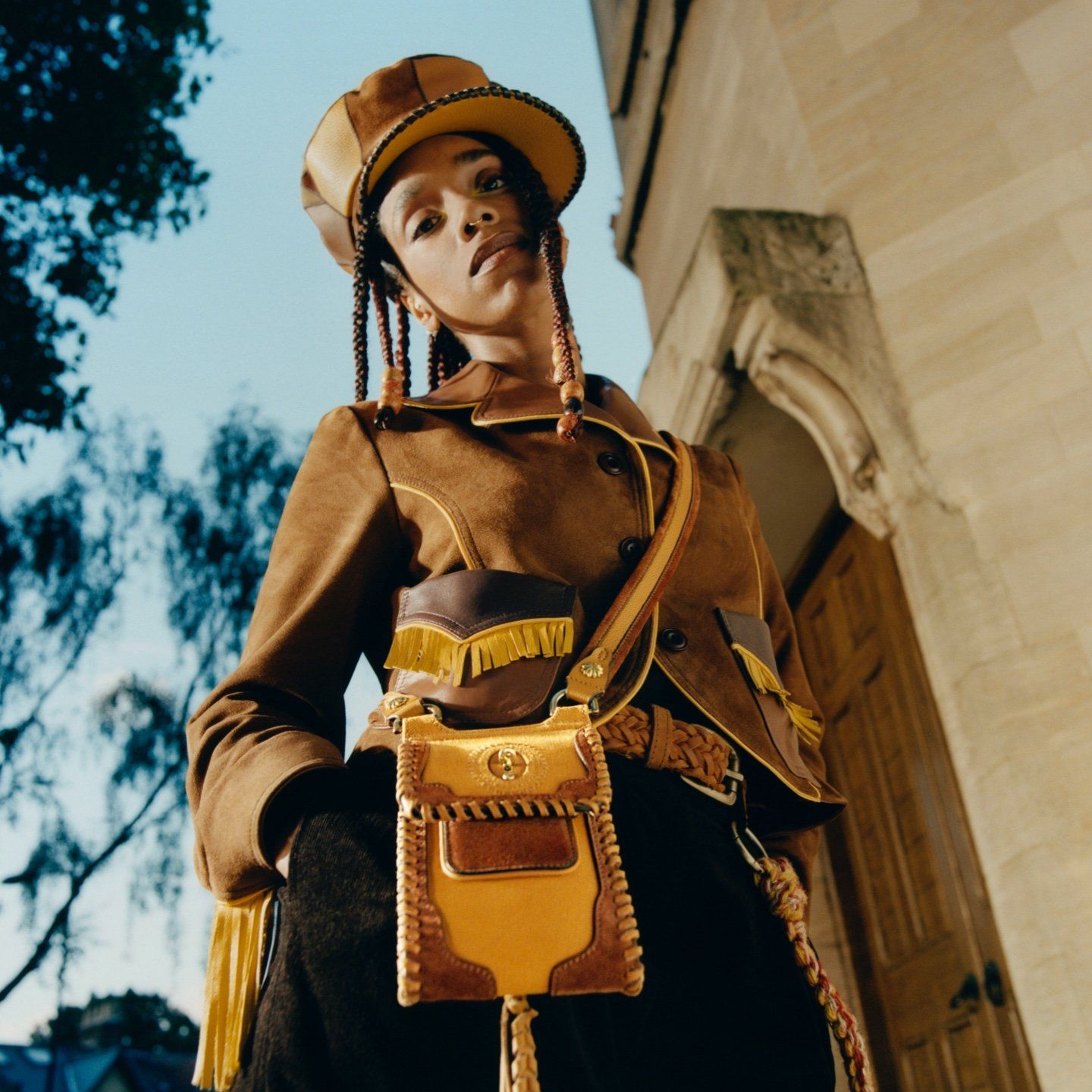 model wearing mulberry and Nicholas daley collaboration mini antony bag in brown and yellow