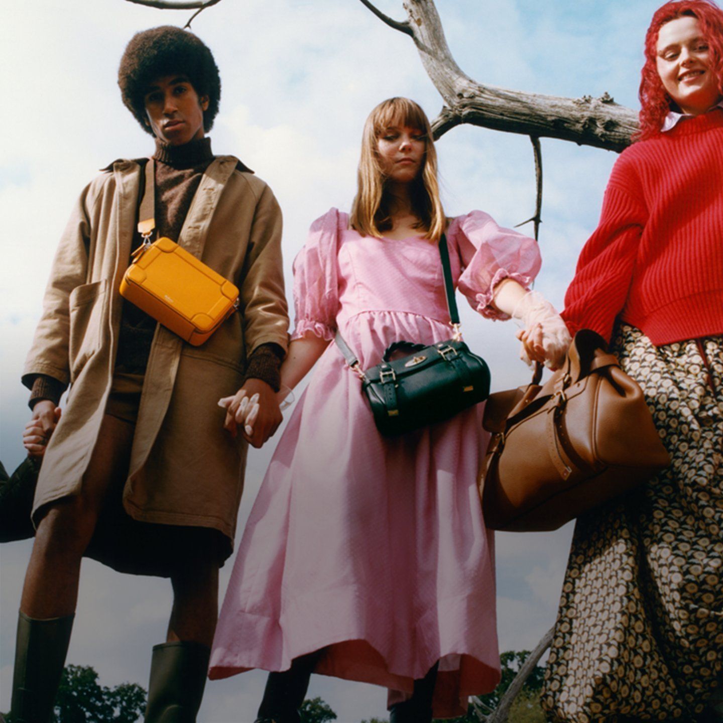 three models wearing mulberry belgrave crossbody bag in double yellow, mini alexa in mulberry green and oversized alexa in chestnut