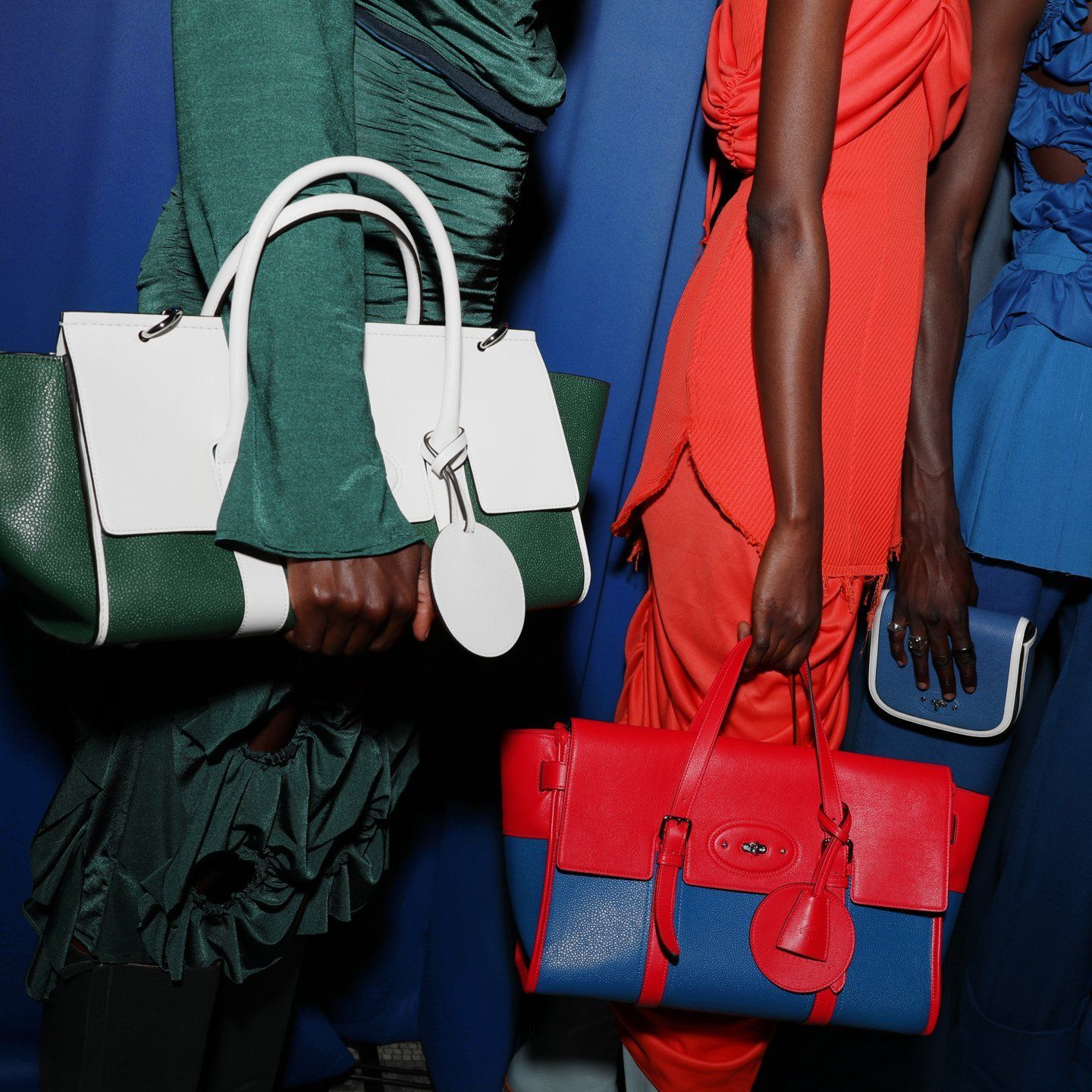 two runway models wearing mulberry x nicholas daley bayswater bags in white and green and red and blue