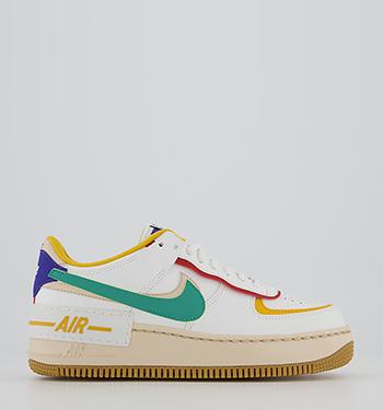 white nike trainers yellow tick