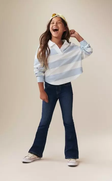 A young model wearing mini flare boot-cut jean.