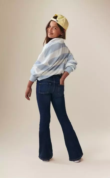 A young model wearing mini flare boot-cut jean.