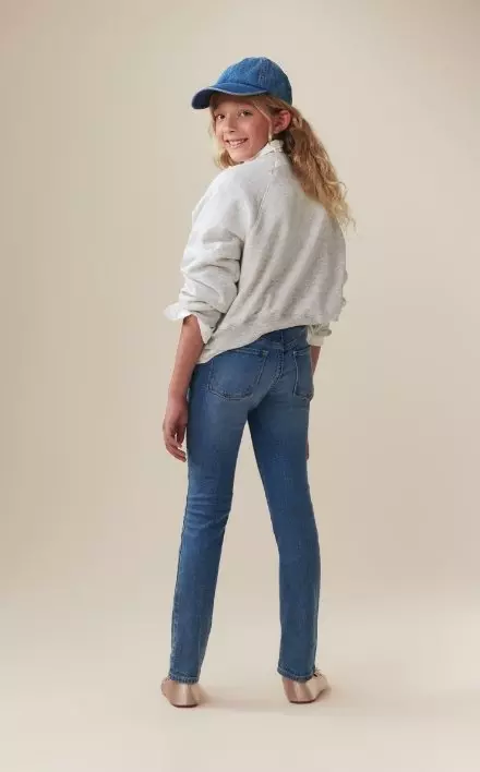 A model dressed in wow skinny pull on jeans for girls.