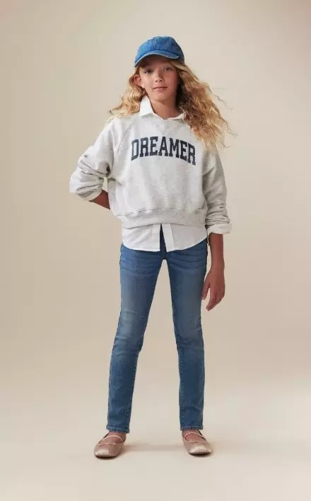 A model dressed in wow skinny pull on jeans for girls.