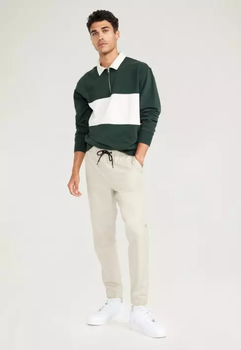 A light color jogger pant with drawstring adjustment.