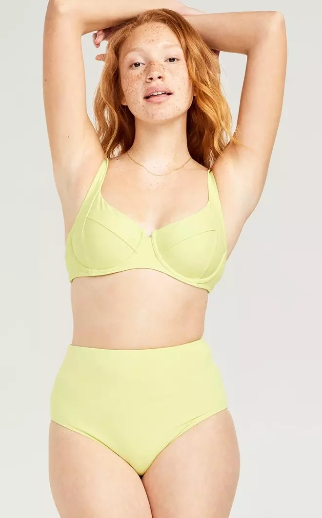 A female model wears a pique underwire bikini top and high waisted French-cut bikini bottom.