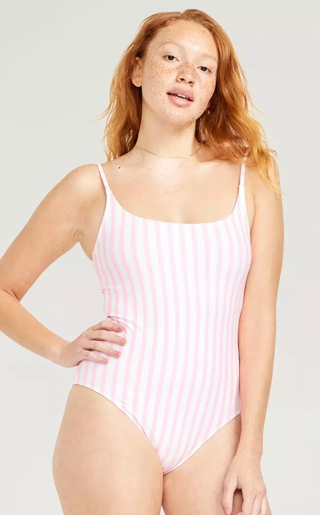 A female model wears a scoop neck, stripe one-piece swimsuit.