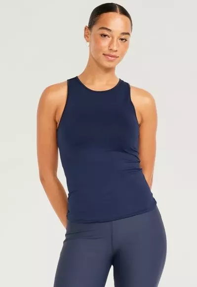 A female model wears a Cutout-Back Performance Tank Top