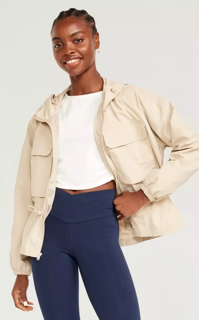 A female model wears a cargo-style activewear jacket