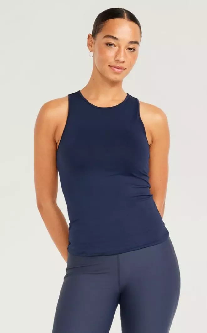 A female model wears a Cutout-Back Performance Tank Top