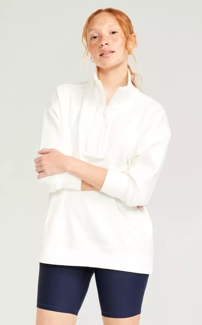 A female model wears a Dynamic Fleece Oversized 1/2-Zip Tunic