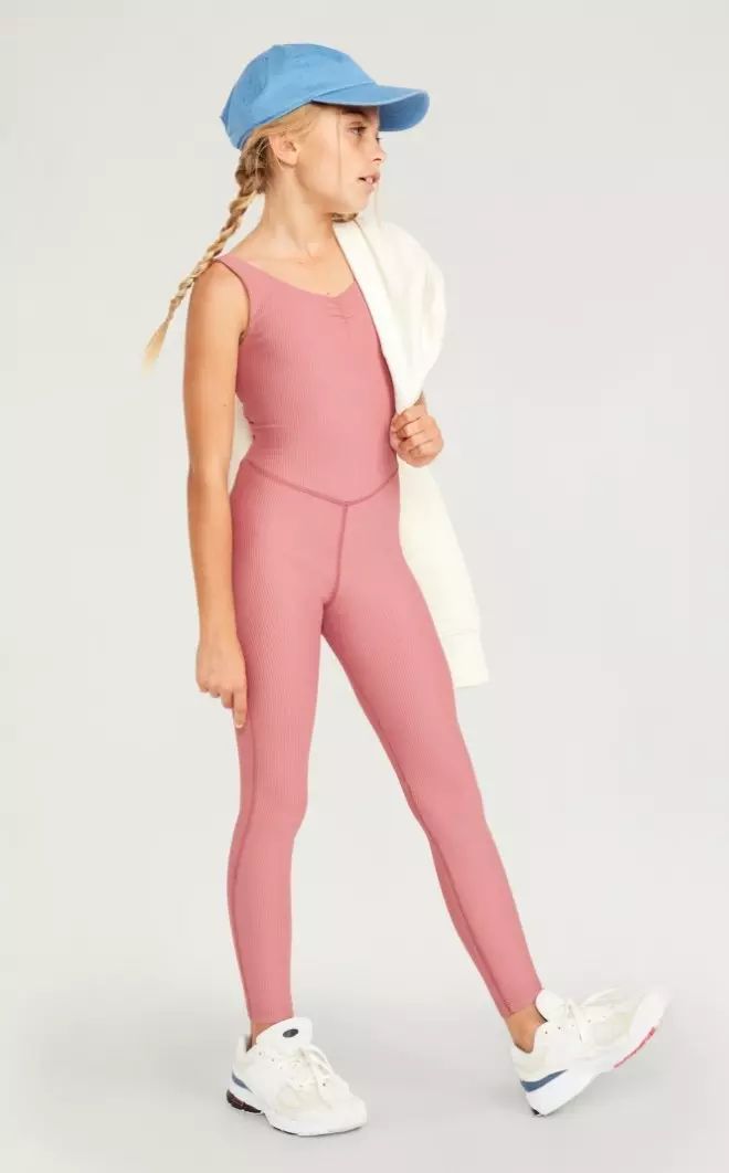 A female model wears a sleeveless PowerSoft 7/8 Bodysuit