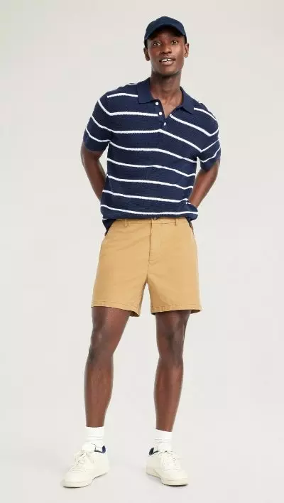 A male model wears light colored Slim Built-In Flex Rotation Chino Shorts