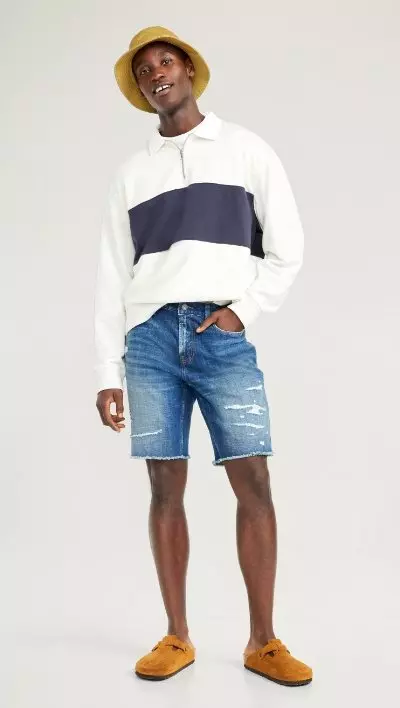 A male model wears a pair of Slim Built-In Flex Cut-Off Jean Shorts for Men -- 9.5-inch inseam
