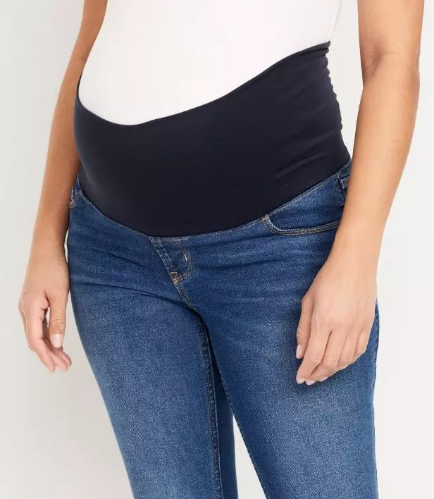 A pregnant model mid bump maternity jeans.