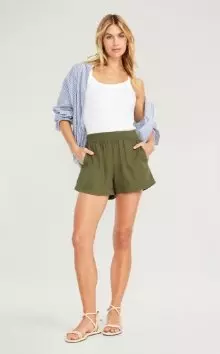 A female model wearing dark green High-Waisted Linen-Blend Pull-On Shorts -- 3.5-inch inseam