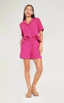 A female model wearing pink High-Waisted Crinkle Gauze Shorts -- 5-inch inseam