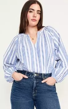 A female model wearing long-sleeve striped top.