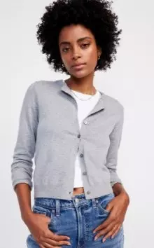 A female model wearing a grey cardigan.