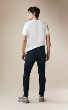 A male model wearing athletic taper jeans.