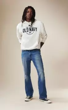 A male model wearing boot-cut jeans and an Old Navy logo hoodie.